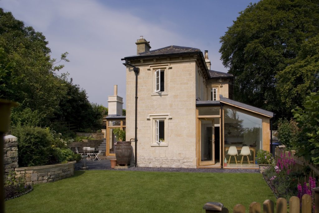 Glazed timber framed extensions to stone workers cottage